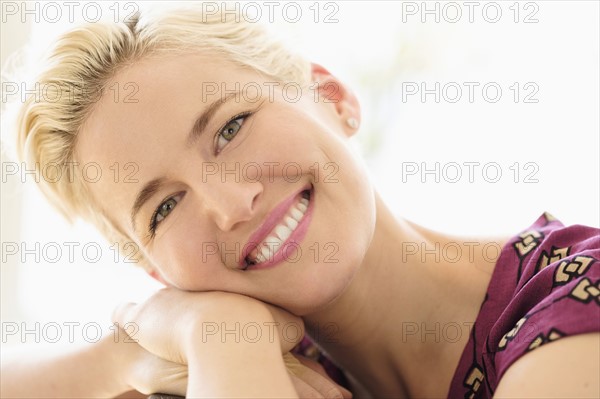 Portrait of smiling young woman indoors.