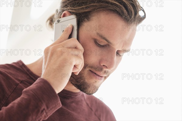 Mid-adult man talking on phone.