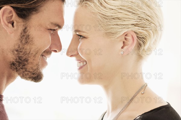 Couple face to face on white background.