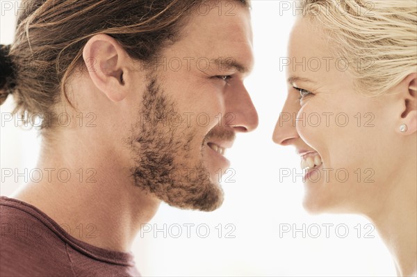 Couple face to face on white background.