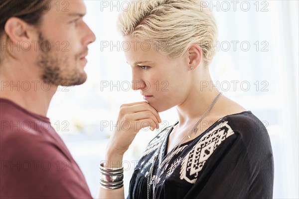 Couple arguing in living room.