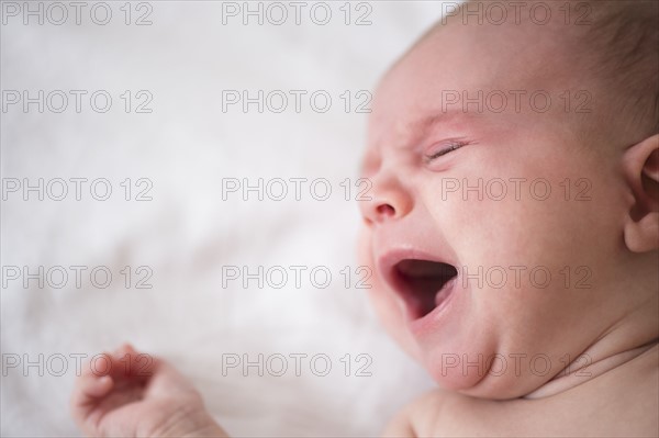 Baby girl (2-5 months) crying in crib