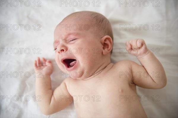 Baby girl (2-5 months) crying in crib