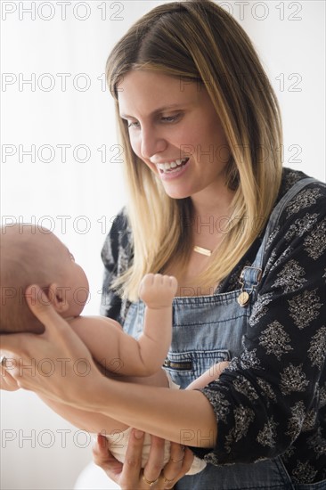 Mother holding baby girl (2-5 months) in her arms