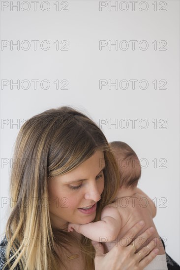 Mother holding baby girl (2-5 months) in her arms