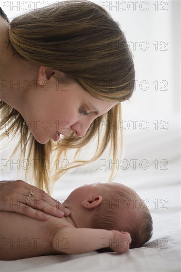 Mother consoling baby girl (2-5 months)