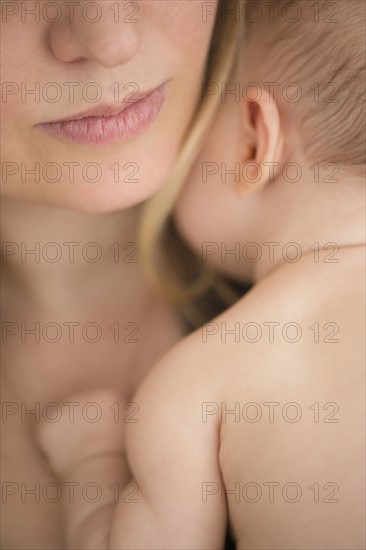 Mother consoling baby girl (2-5 months)