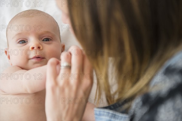 Mother consoling baby girl (2-5 months)