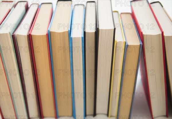 Row of books on white background
