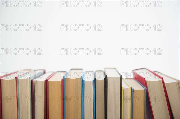 Row of books on white background