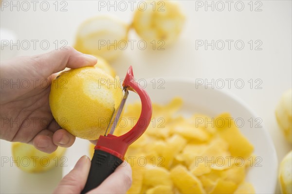 Personal point of view of person peeling lemons