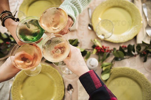 Personal perspective of people with martini glasses at festive table
