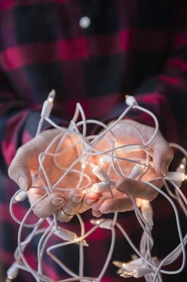 Person holding Christmas lights