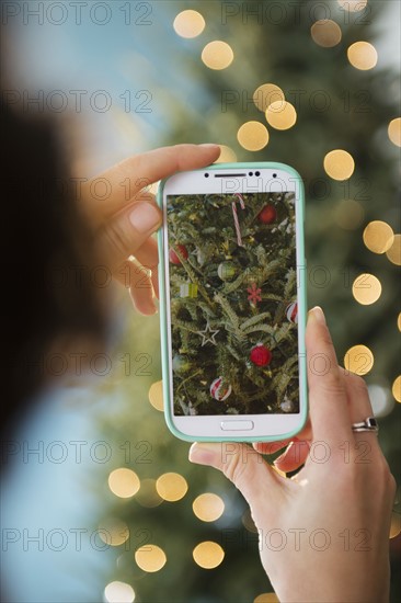 Personal perspective of person photographing Christmas tree