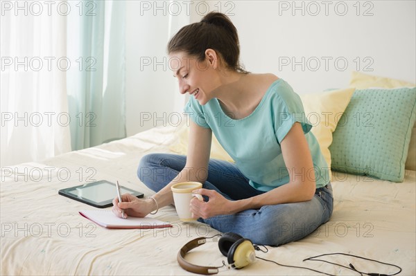 Woman in bedroom working