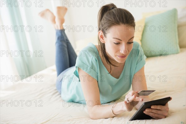 Woman shopping online in bed