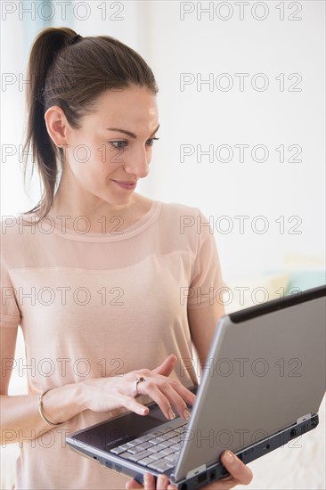 Woman using laptop at home