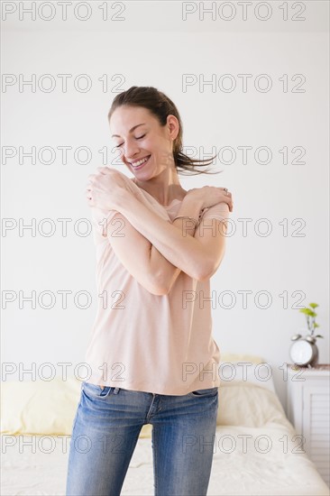 Smiling woman in bedroom