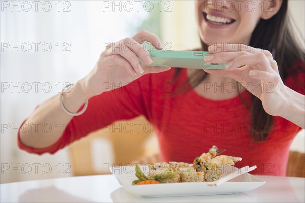 Woman taking picture of meal with Smartphone