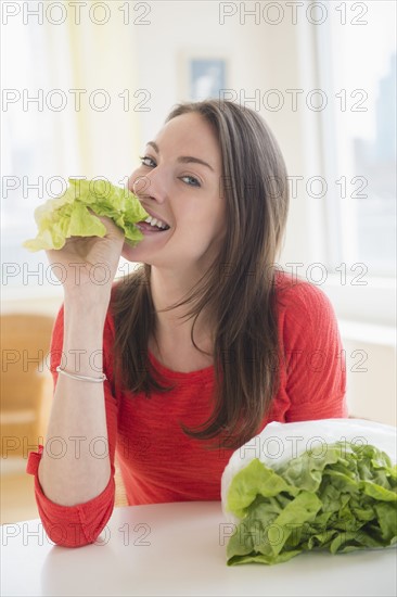 Woman eating lettuce