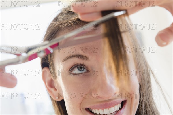 Woman cutting her hair