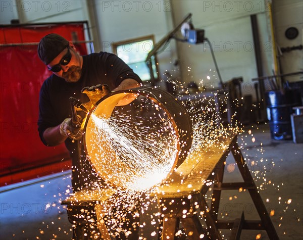 Welder working in metal workshop