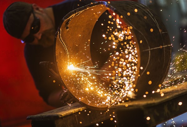 Welder working in metal workshop