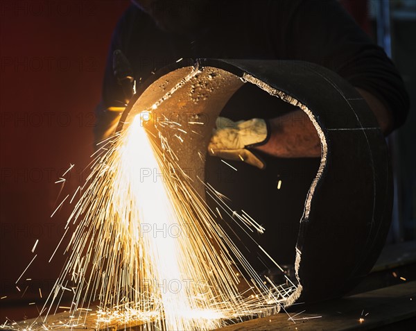 Welder working in metal workshop