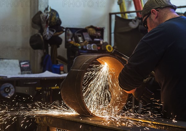 Welder working in metal workshop