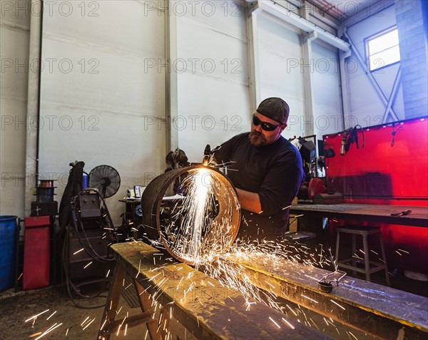 Welder working in metal workshop