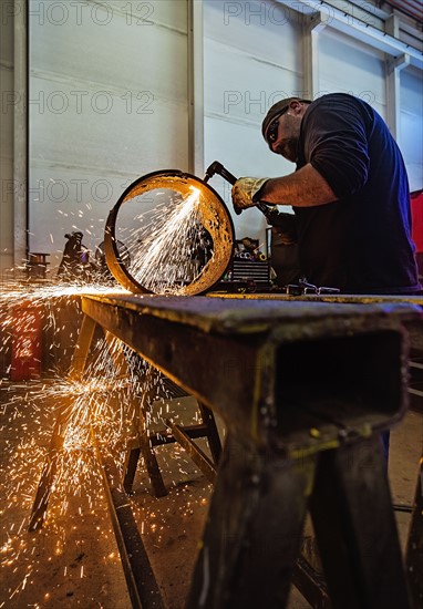 Welder working in metal workshop