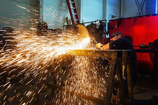 Welder working in metal workshop