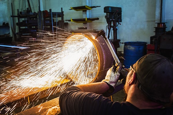 Welder working in metal workshop