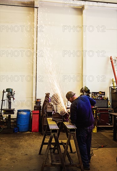 Welder working in metal workshop