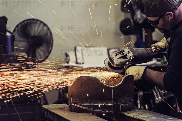 Welder working in metal workshop