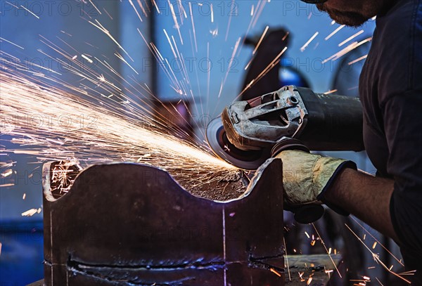 Welder working in metal workshop