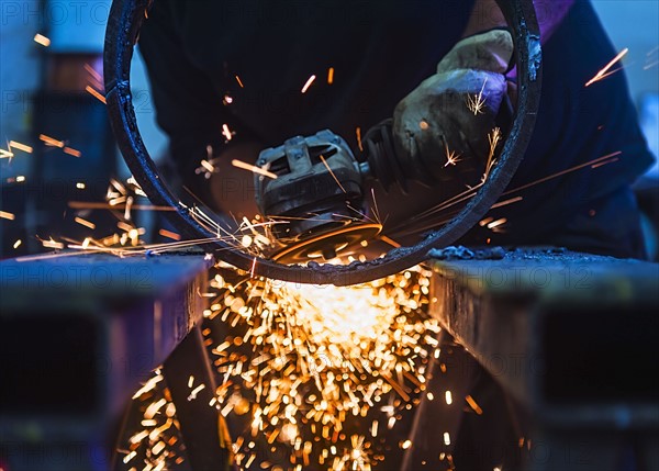 Welder working in metal workshop