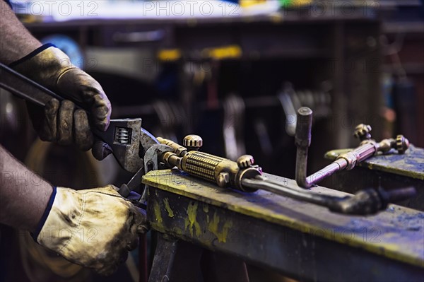 Close-up of man working in metal workshop