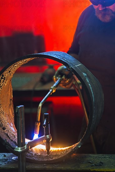 Welder working in metal workshop