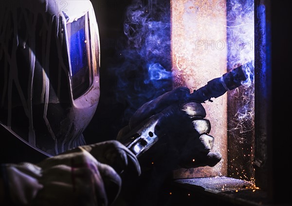 Man in welding mask working