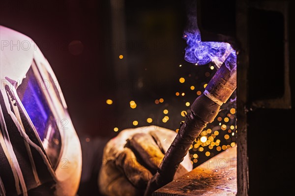 Man in welding mask working