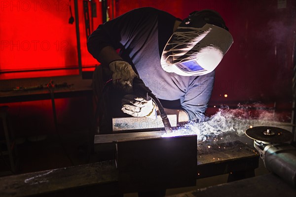 Man in welding mask working