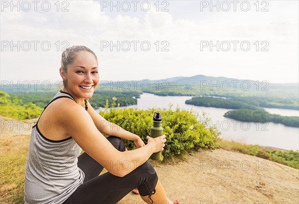 Smiling young female hiker resting
