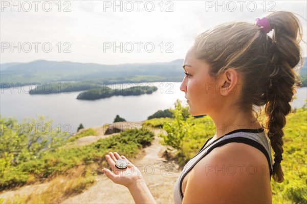 Young woman holding compass