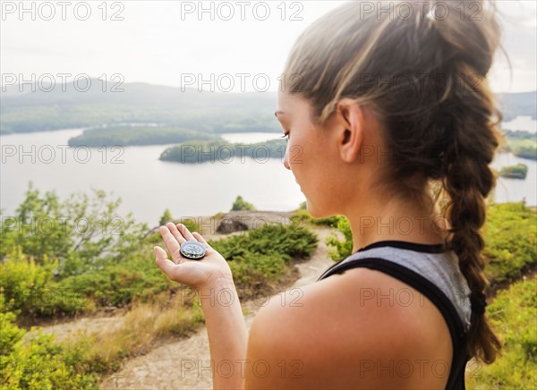 Young woman holding compass