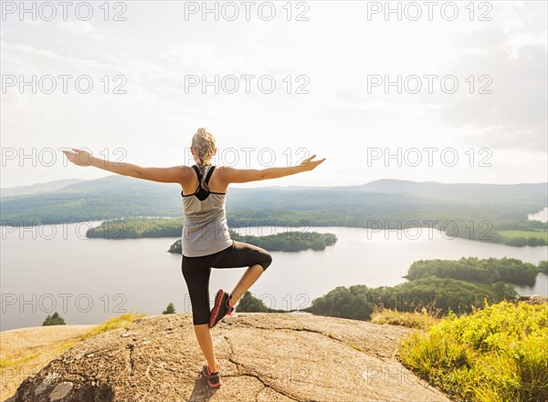 Rear view of young woman exercising outdoor