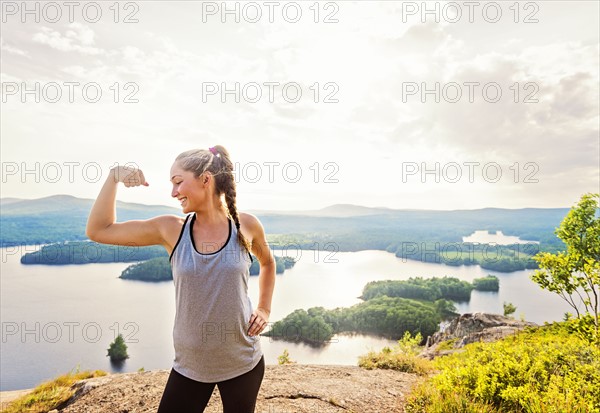 Young woman flexing muscles