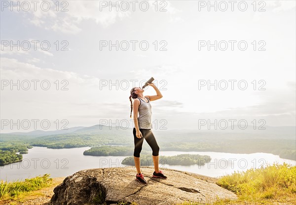 Woman drinking water after doing exercises