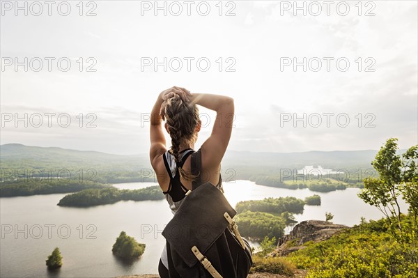 Rear view of young woman looking at lake