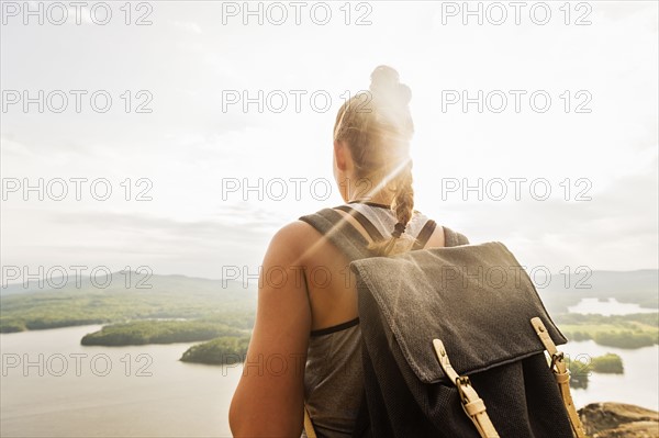 Rear view of young woman looking at lake